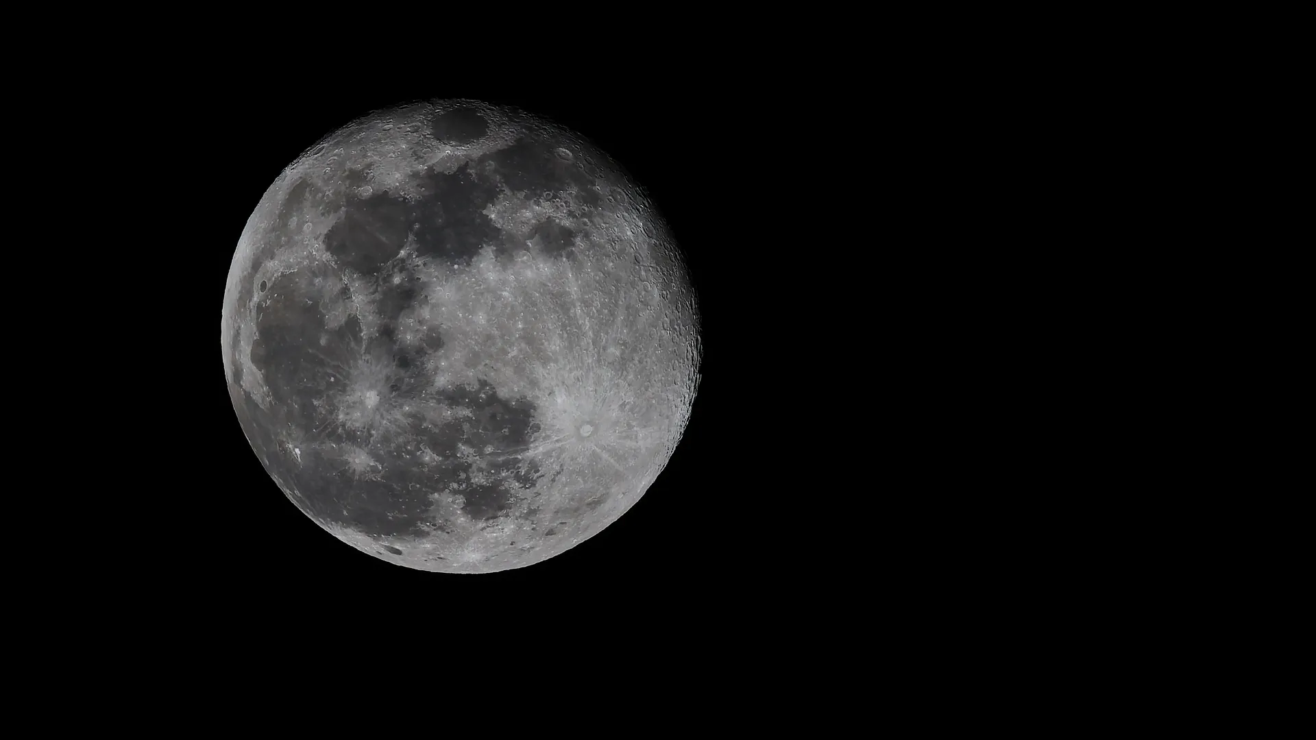 Full moon with visible craters against a black night sky